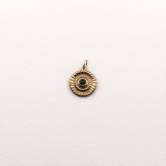 Solid gold circular pendant with a rose cut montana sapphire cabochon 