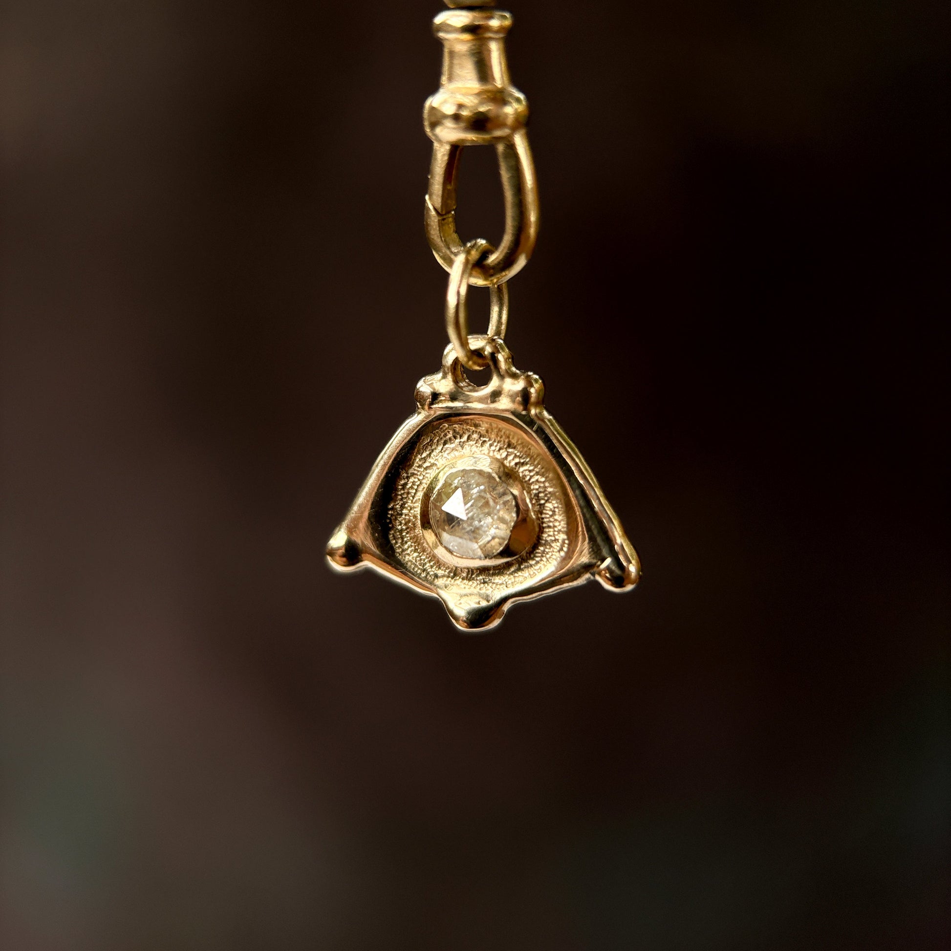 solid gold evil eye with a rose cut diamond