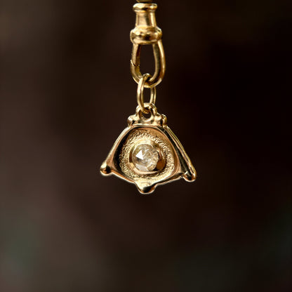solid gold evil eye with a rose cut diamond